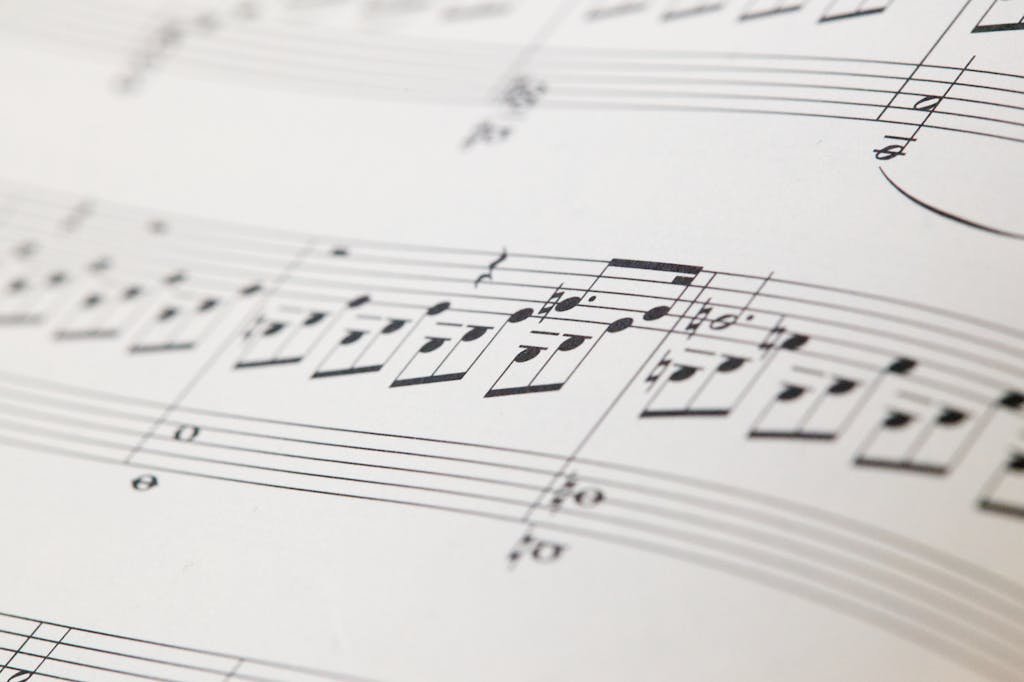 Detailed view of printed musical notes on a white sheet of paper.